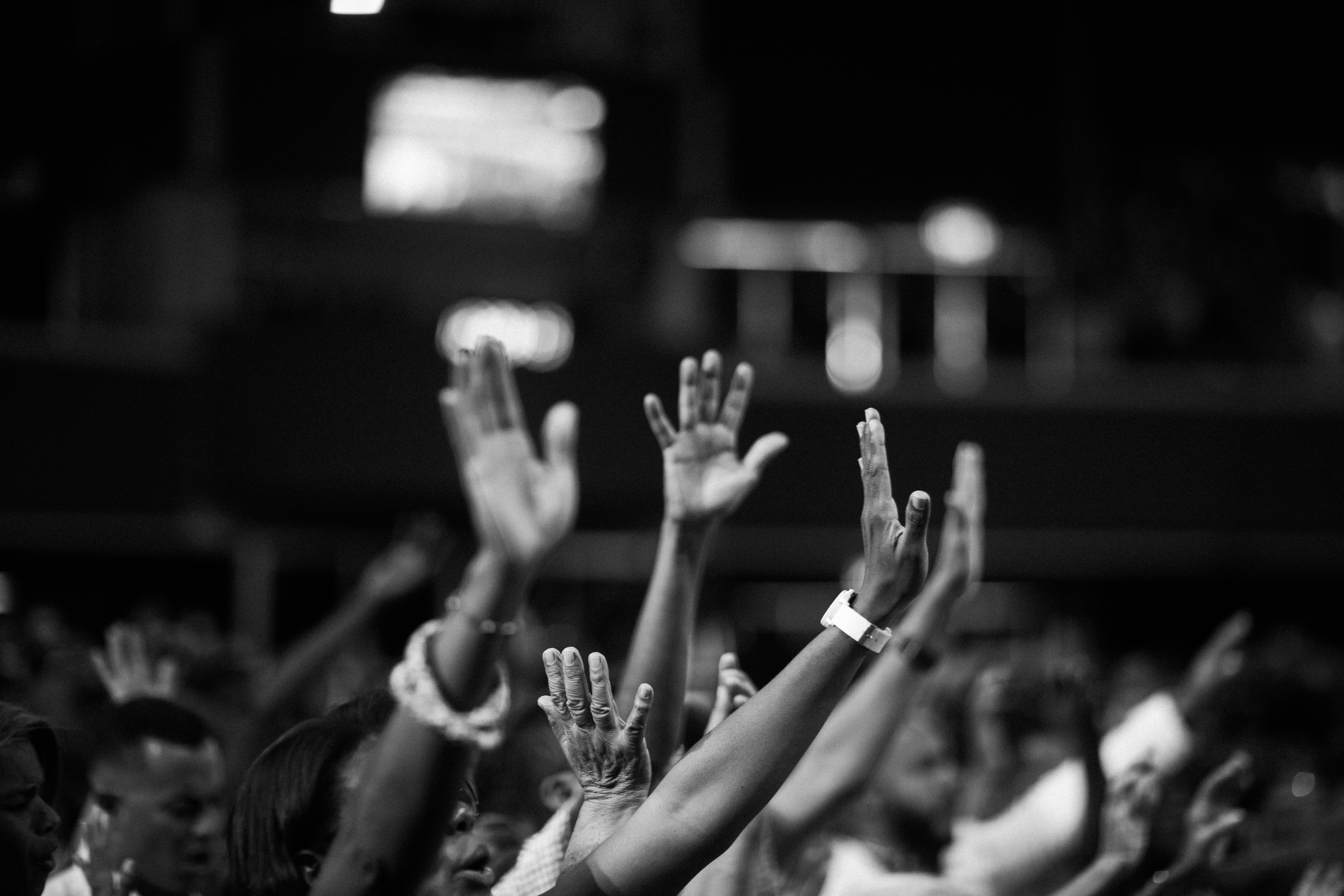 grayscale-photography-of-people-raising-hands-2014775.jpg